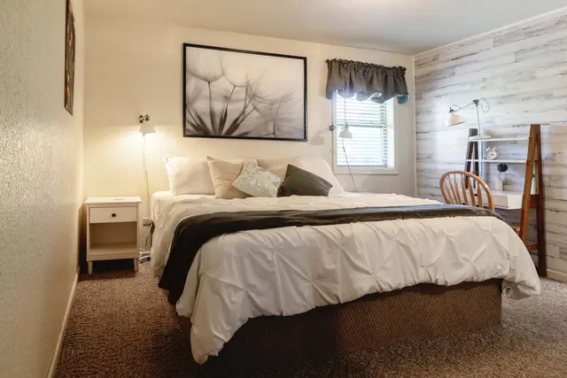 King bedroom with shiplap wall